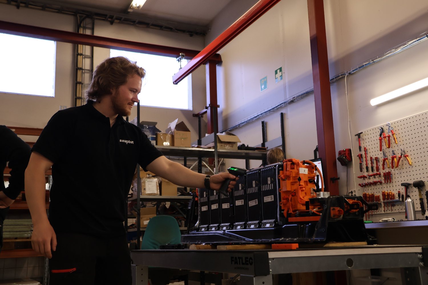 Swapbat technician scanning a reassembled battery pack for its digital record