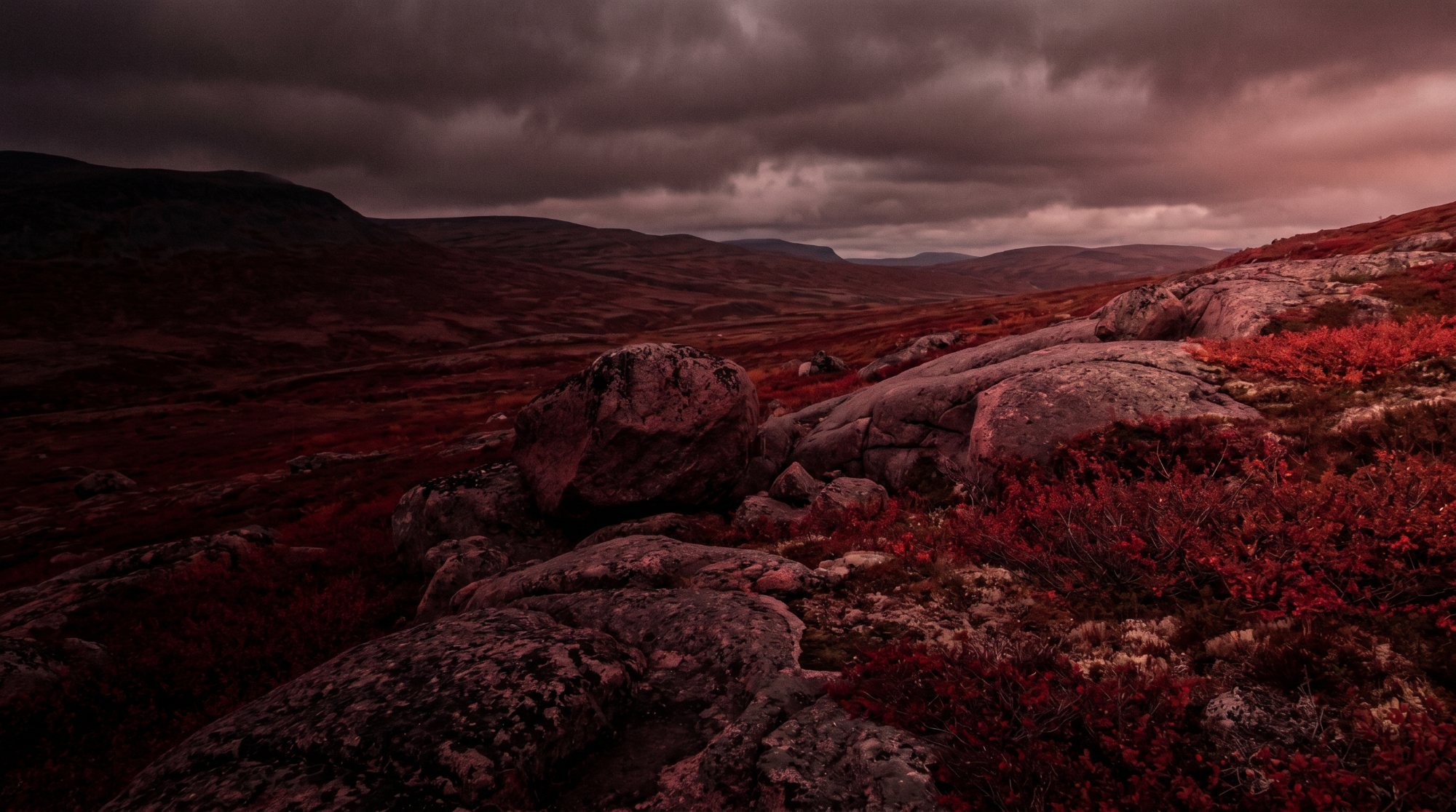 Red-tinted Nordic fell landscape at dusk