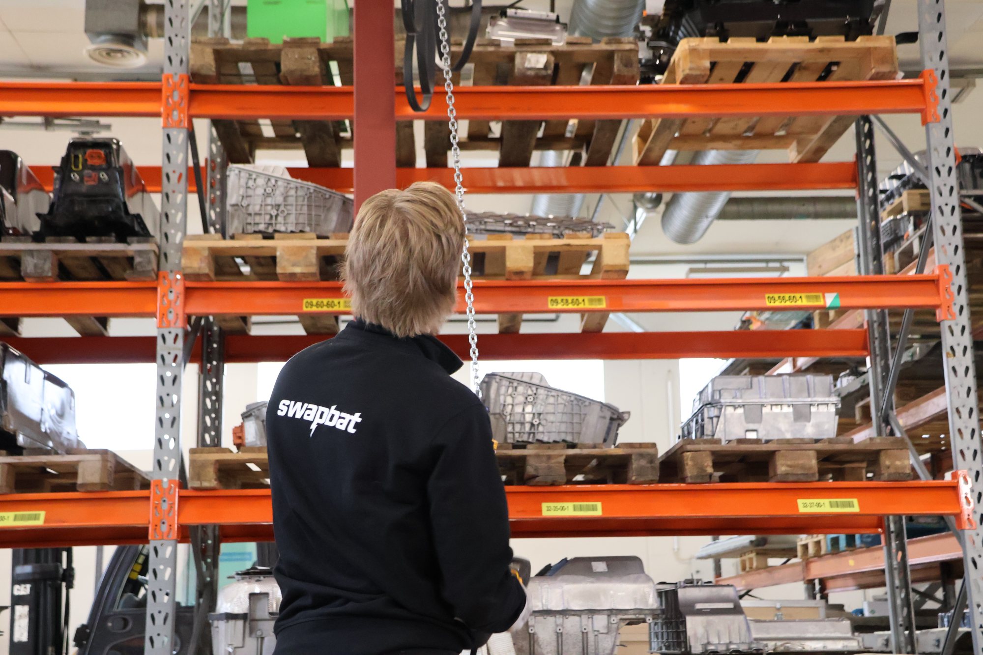 Swapbat team member at the remanufacturing facility racks